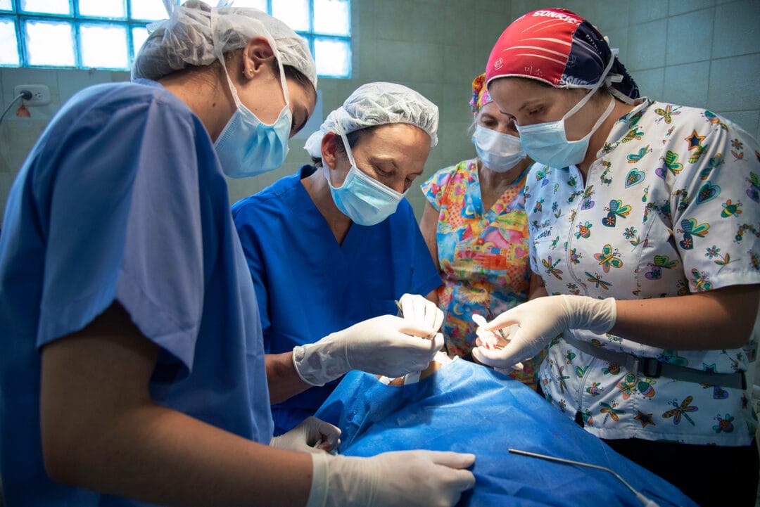 Operation Smile medical director and cleft surgeon Dr. Mauricio Herrera, centre, operates as surgical resident Dr. Andrea Tavera, anaesthesiologist Dr. Raquel Cohen and operating room nurse Geraldin Rodriguez assist during Pedro's surgery. Photo: Rohanna Mertens