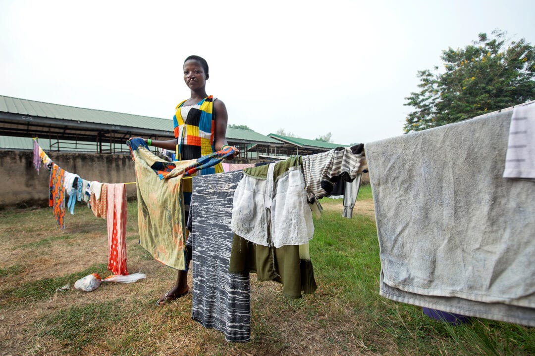 Faustina, before cleft surgery, doing chores