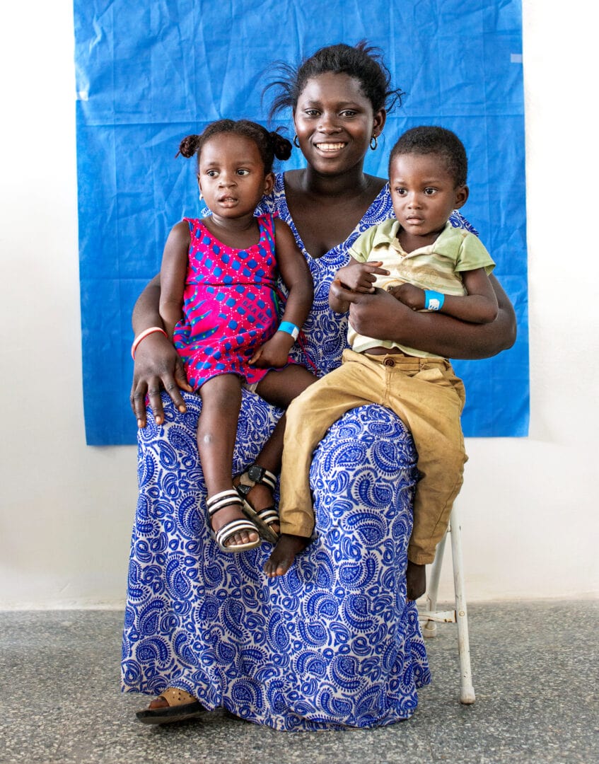 Two-years-old Afia with her twin brother and mum, back to a medical programme to repair cleft palate. Smile Photo: Zute Lightfoot
