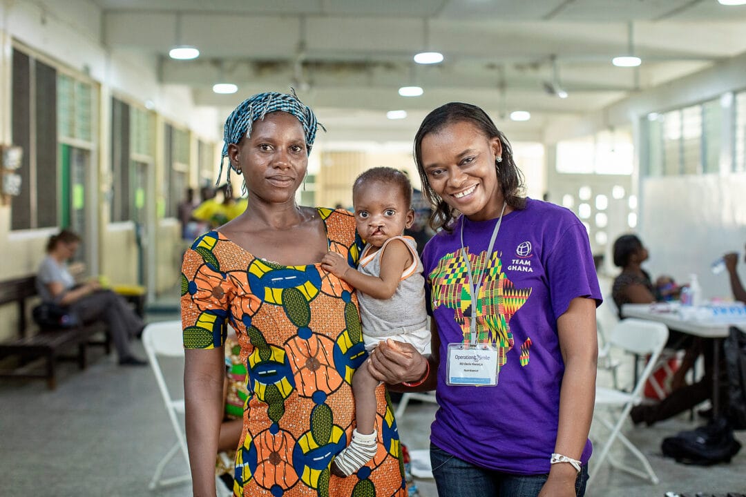 Baby boy with cleft lip held by his mum before his cleft lip surgery with Nutritionist Dede Kwadjo, Ghana Operation Smile Ghana's first local programme