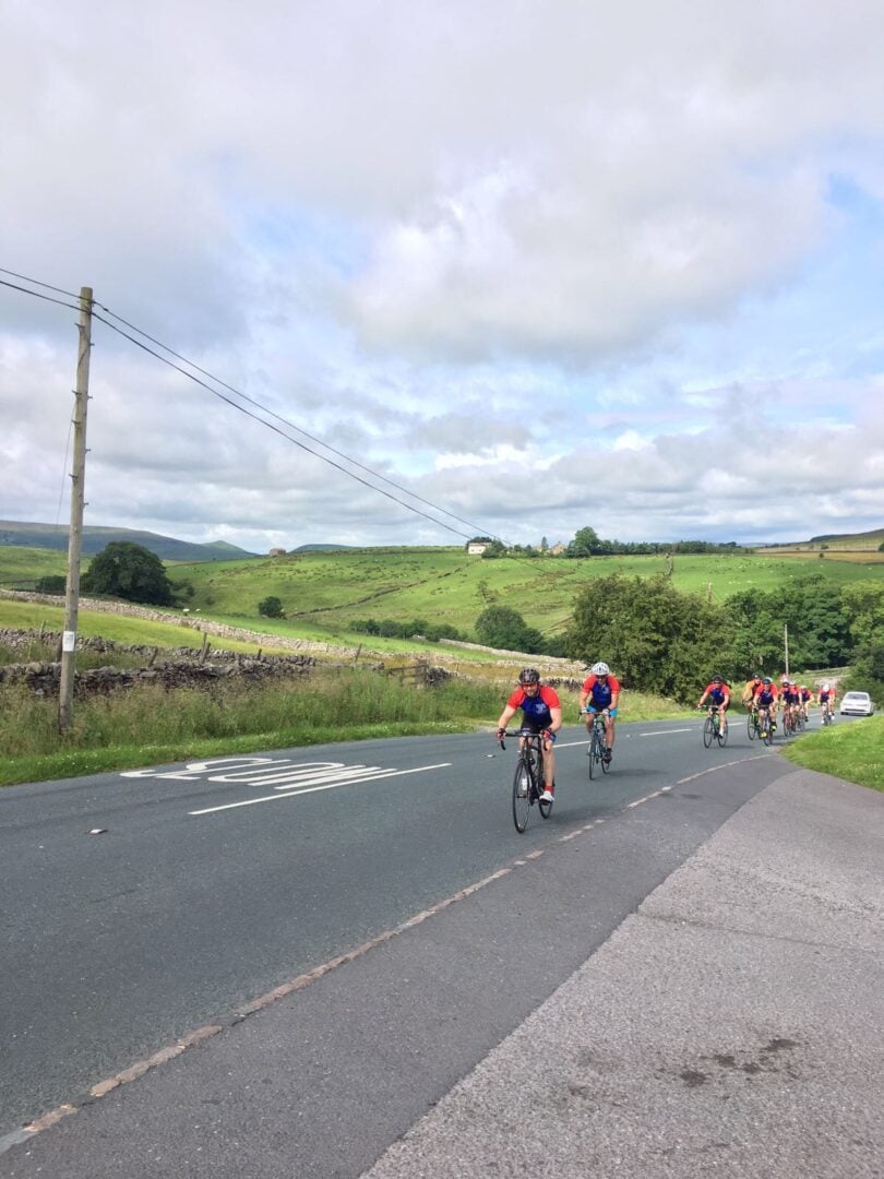 Cyclists wearing operation smile cycling jersey