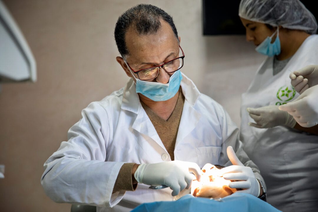 Orthodontist Oussehal Lahcen examining patient. Photo - Lorenzo Monacelli