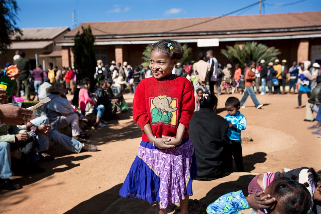 Clara plays as her father Dede waits in line to find out if she has been scheduled for surgery. Photo: Zute Lightfoot