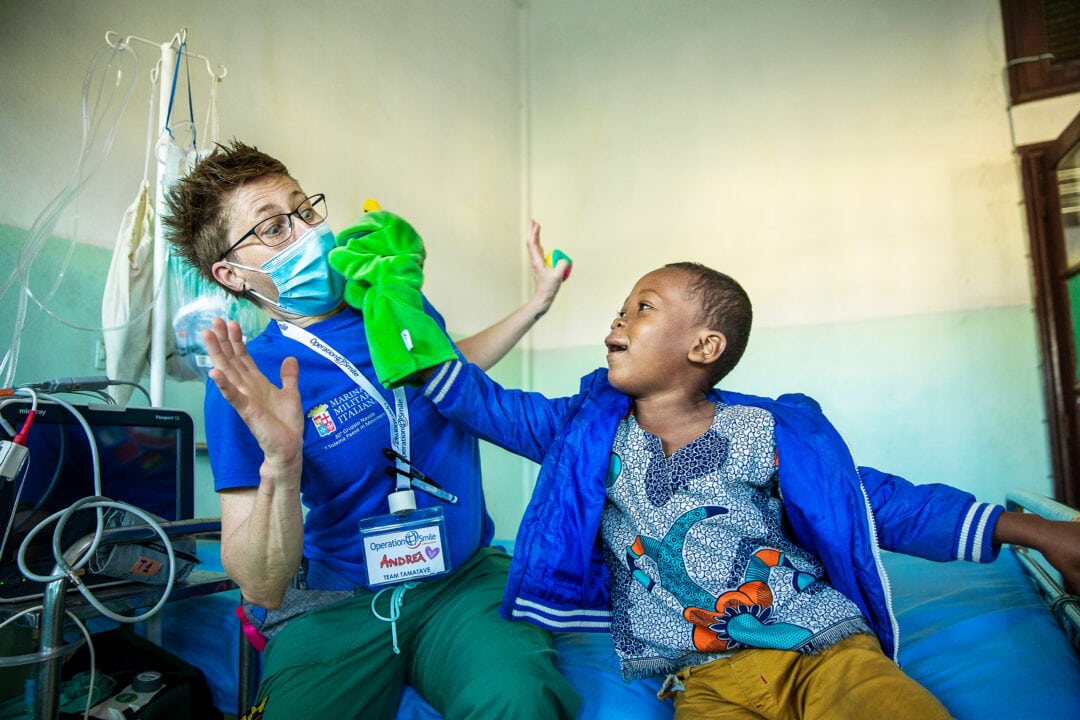 Honoré plays with volunteer nurse, after cleft surgery. Photo: Jorgen Hildebrandt