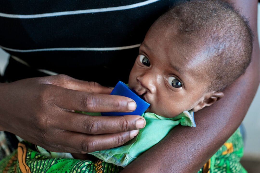Malnourished baby being cup fed.  Photo: Margherita Mirabella