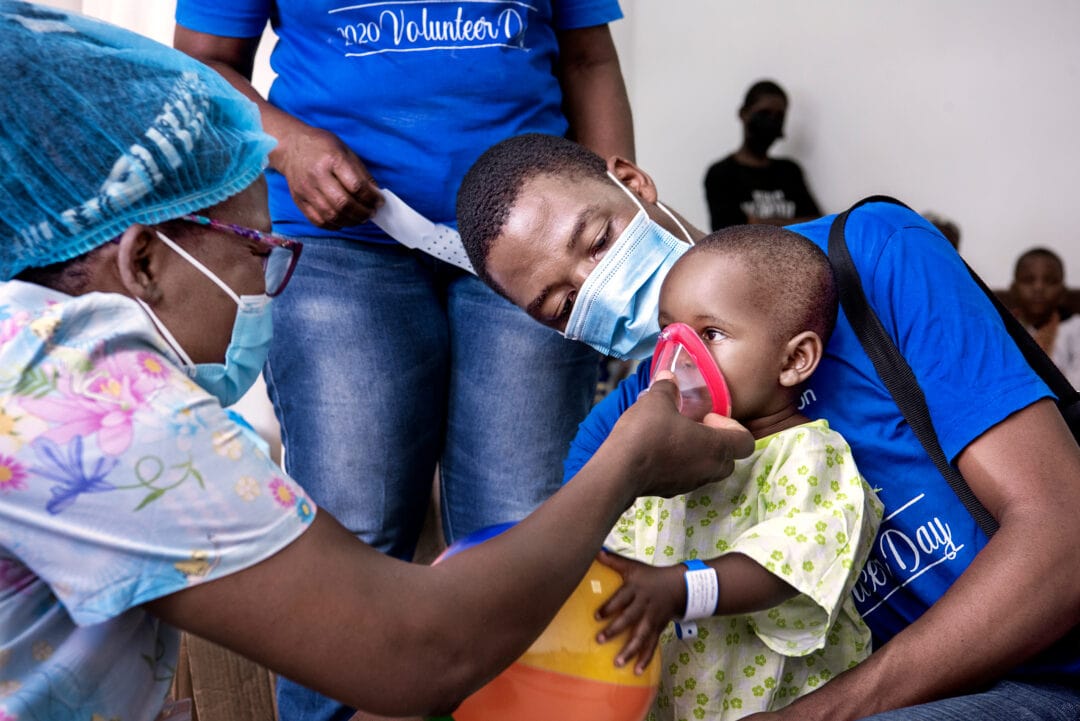 Cathy Cheonga showing getting baby Julita used to what happens before her cleft surgery. Photo: Margherita Mirabella