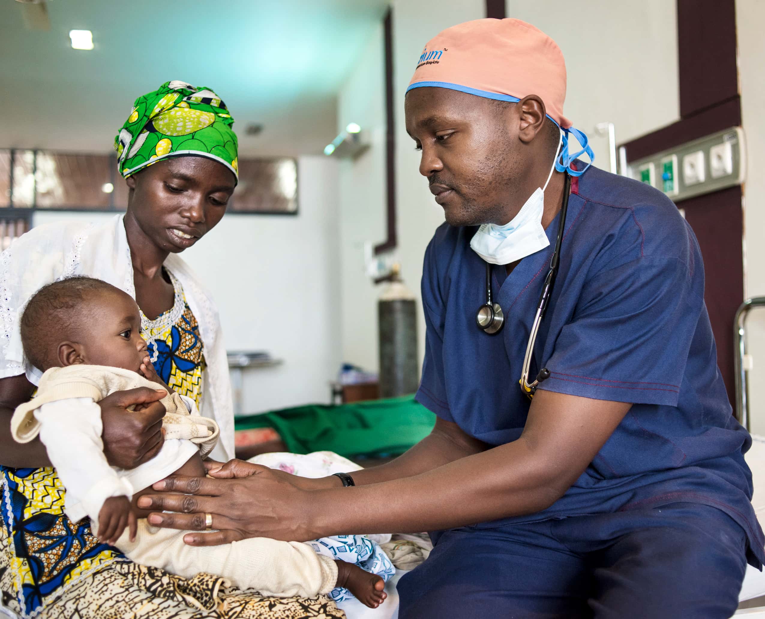 Medical staff tends to baby with a cleft lip