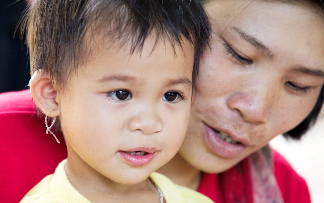 Baby girl with her mum after cleft surgery