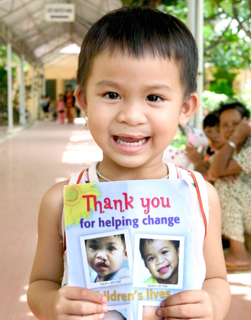 Ngan holding poster with her before cleft surgery and after images 