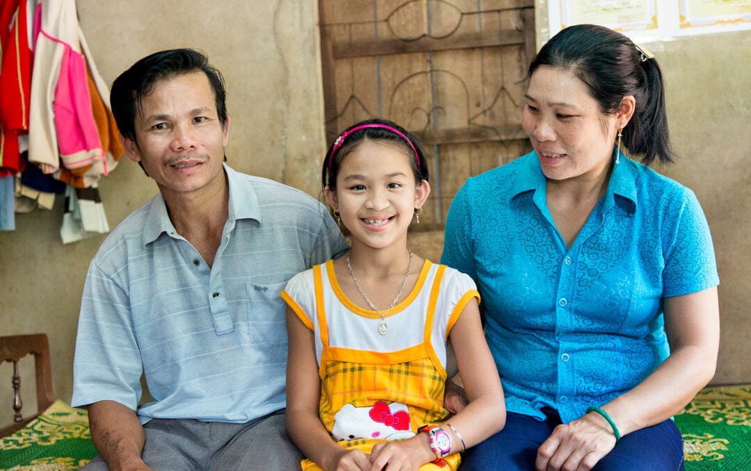 Female girl with mum and dad after cleft surgery