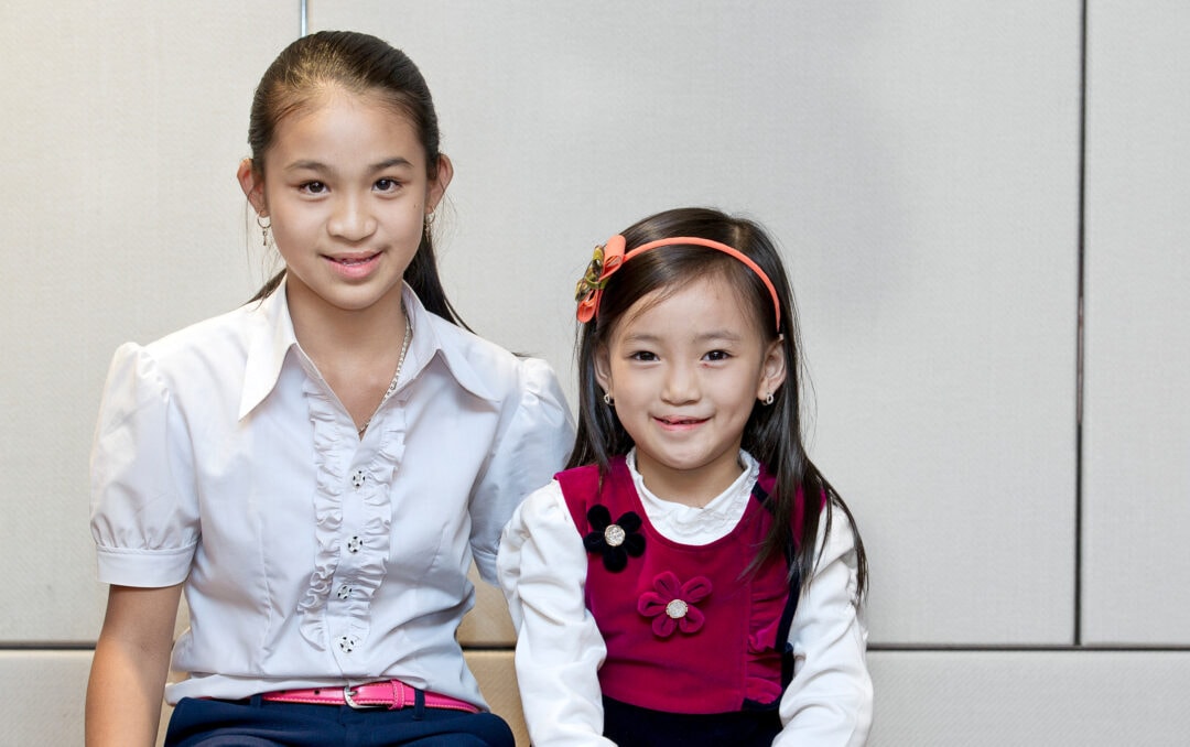 Teen girl with sister after cleft surgery