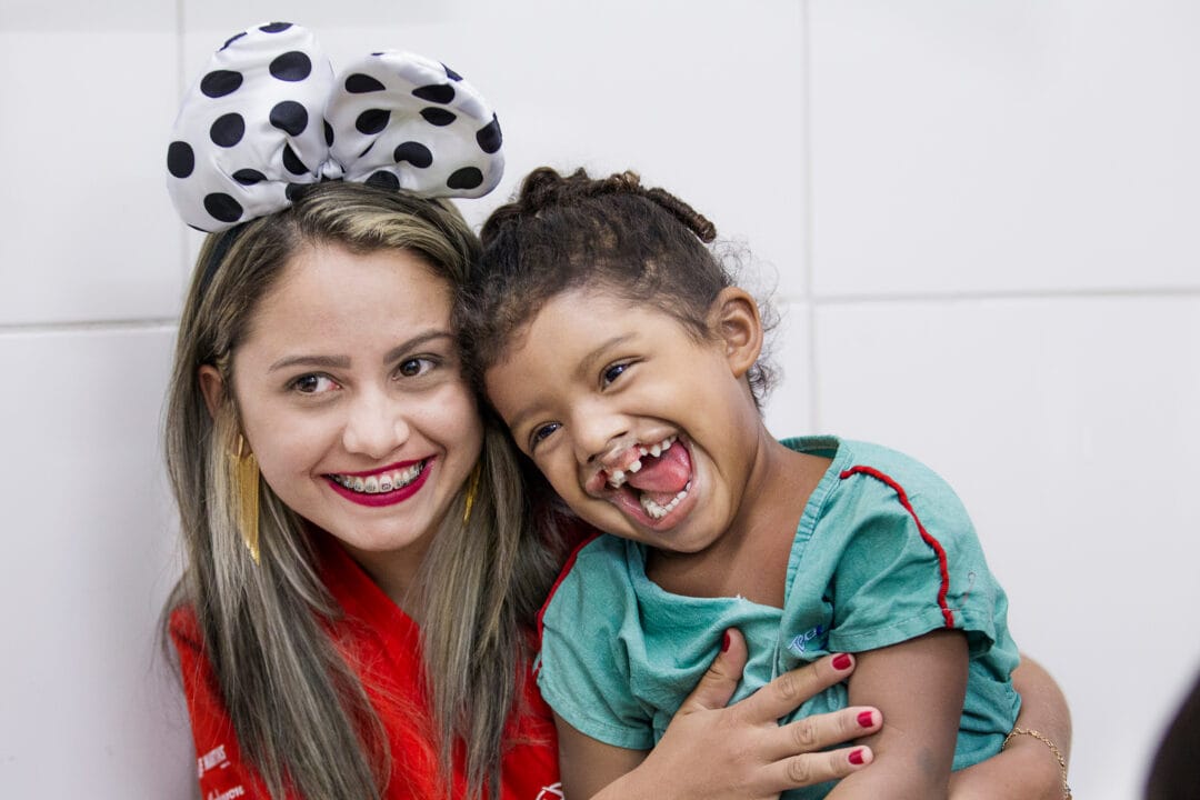 Antonia plays with four-years-old Maria, before cleft surgery. Photo: Marc Ascher