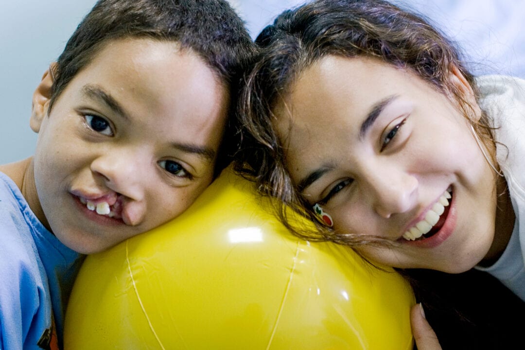 Haytham plays joyfully with student, Lou Callizo before the start of his surgery. Photo: Tyler Barrick