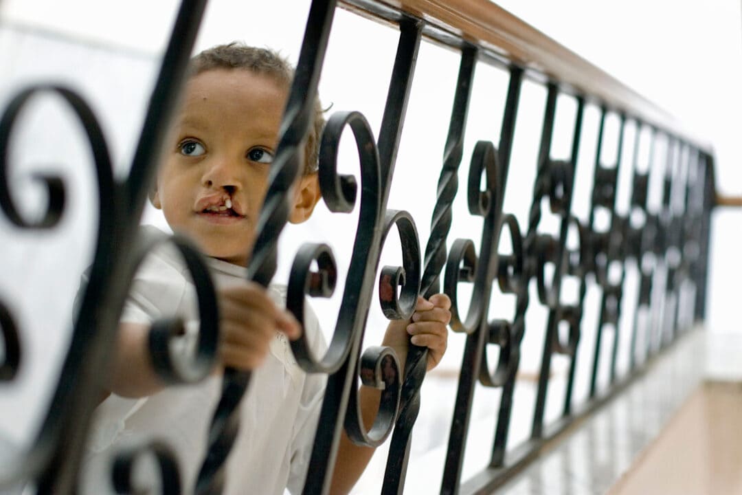 Three-years-old Ahmed plays on the steps of the hospital in Qena, Egypt. Photo: Tyler Barrick