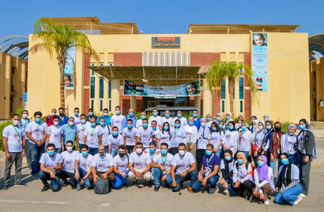 Operation Smile Egypt volunteers and Libyan volunteers come together and pose for a team picture in front of the Assiut University Paediatric Hospital. Operation Smile photo.