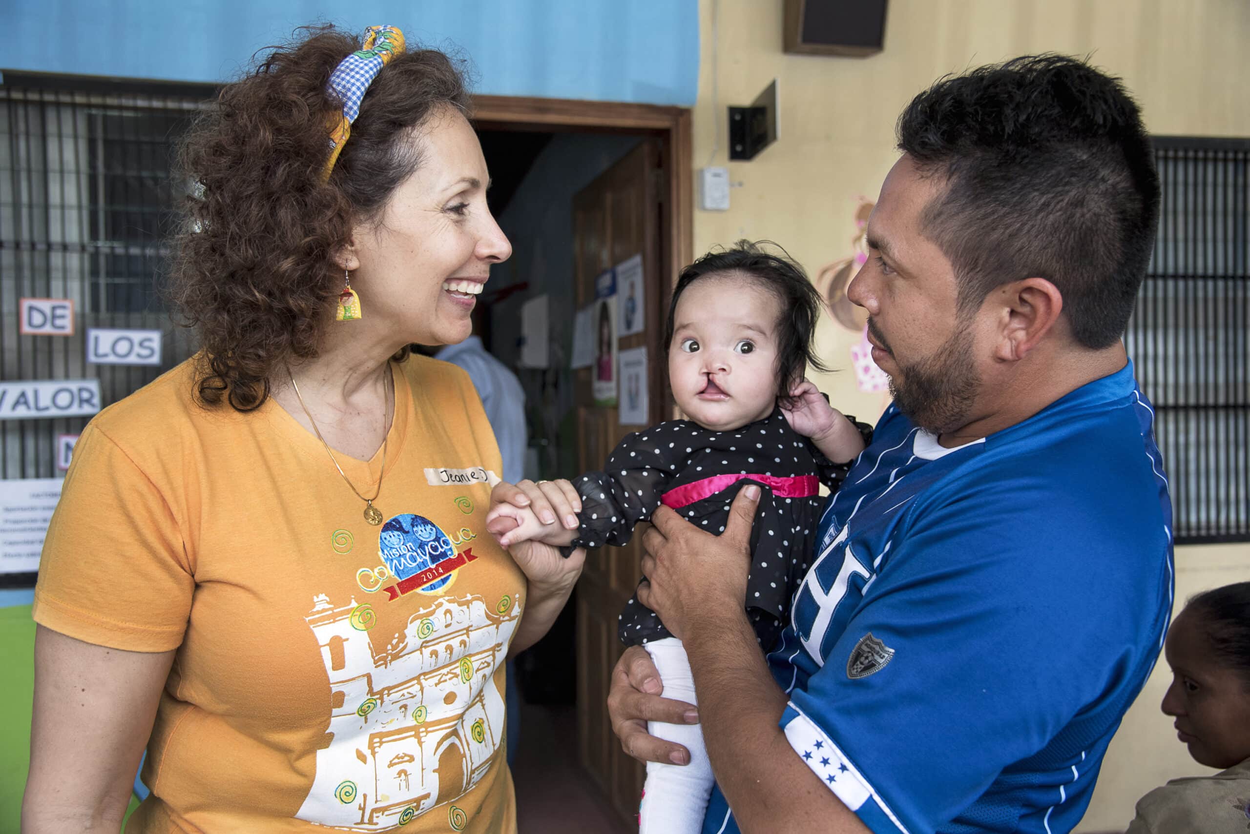 Jeanie Barjum, Executive Director at Operation Smile Honduras, with a patient and her father. Photo: Rohanna Mertens