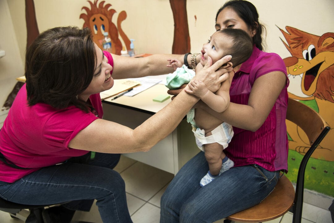 Audiologist and speech therapist Gloria Vilchez examines a young cleft patient. Photo: Rohanna Mertens