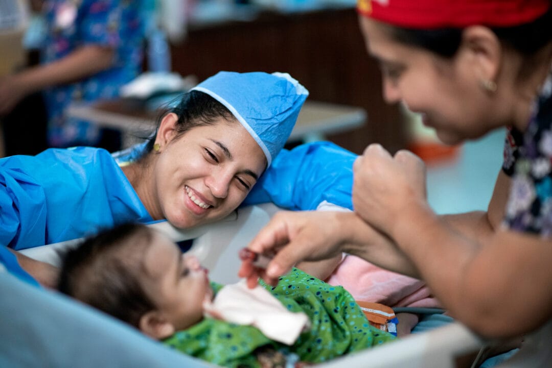 Gloria sees her six-month-old daughter Ammy for the first time after cleft surgery. Photo: Rohanna Mertens