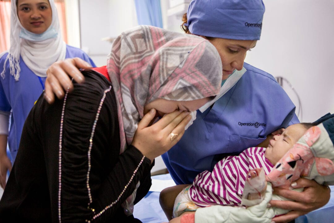 Three-month-old Suliman's mother sees her son for the first time  after cleft surgery. Photo: Jasmin Shah