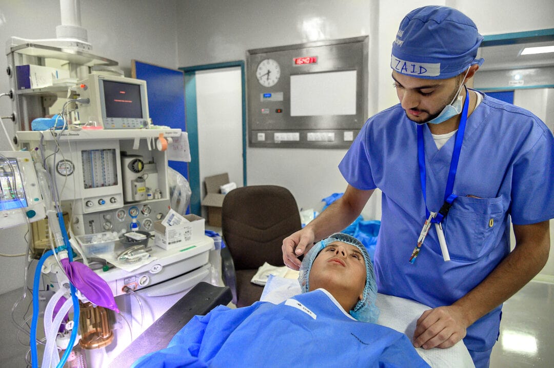 Volunteer Plastic Surgeon-Resident Zaid Al-Ali talks to 12 year-old Majd just before his surgery Operation Smile's programme in Madaba. Photo: Rohanna Mertens