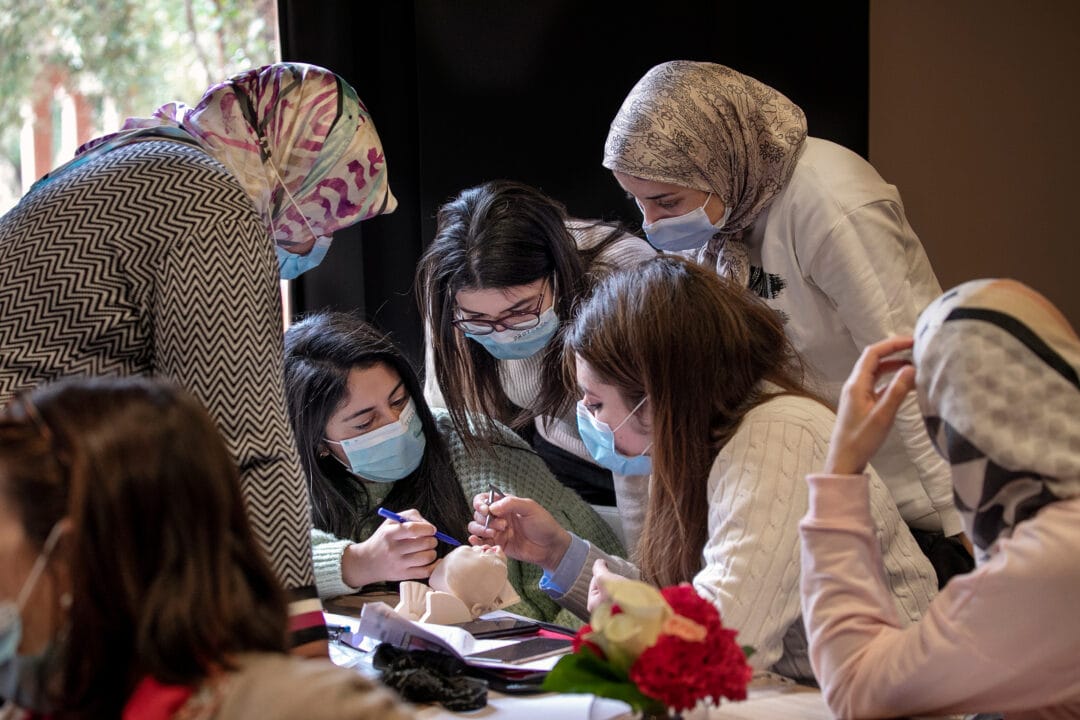 Group of volunteers mentoring local medical staff