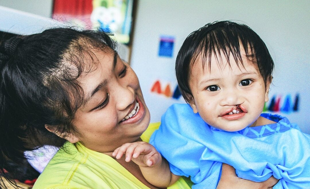 Shennene holds her 1-year-old son, George