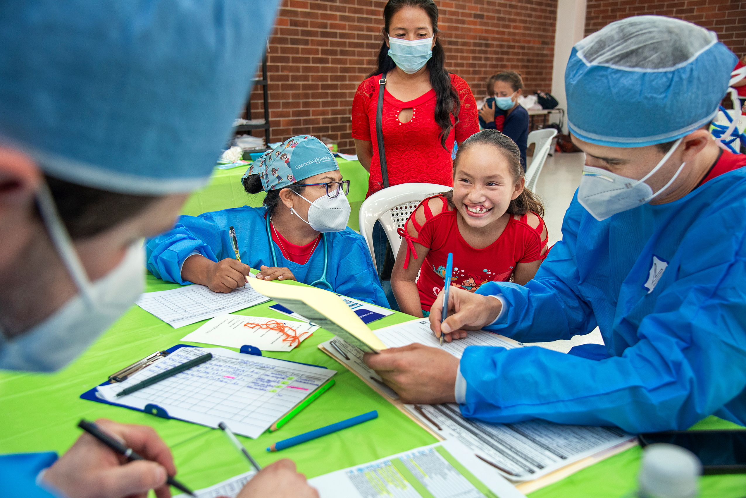 girl with cleft lip with team of medical volunteers in providing cleft care in Guatemala