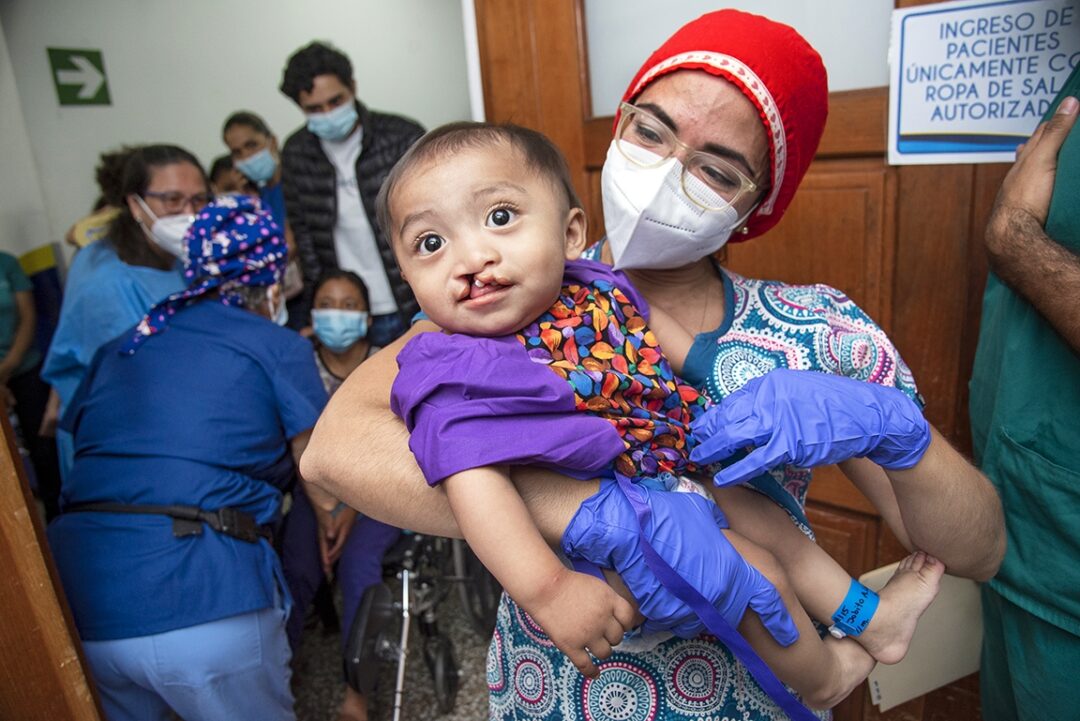 Volunteer Anaesthesiologist Dr. Diana Gutierrez carries 10-month-old Jobito into the operating room during Operation Smile’s 2022 surgical program in Guatemala City. Photo: Rohanna Mertens.