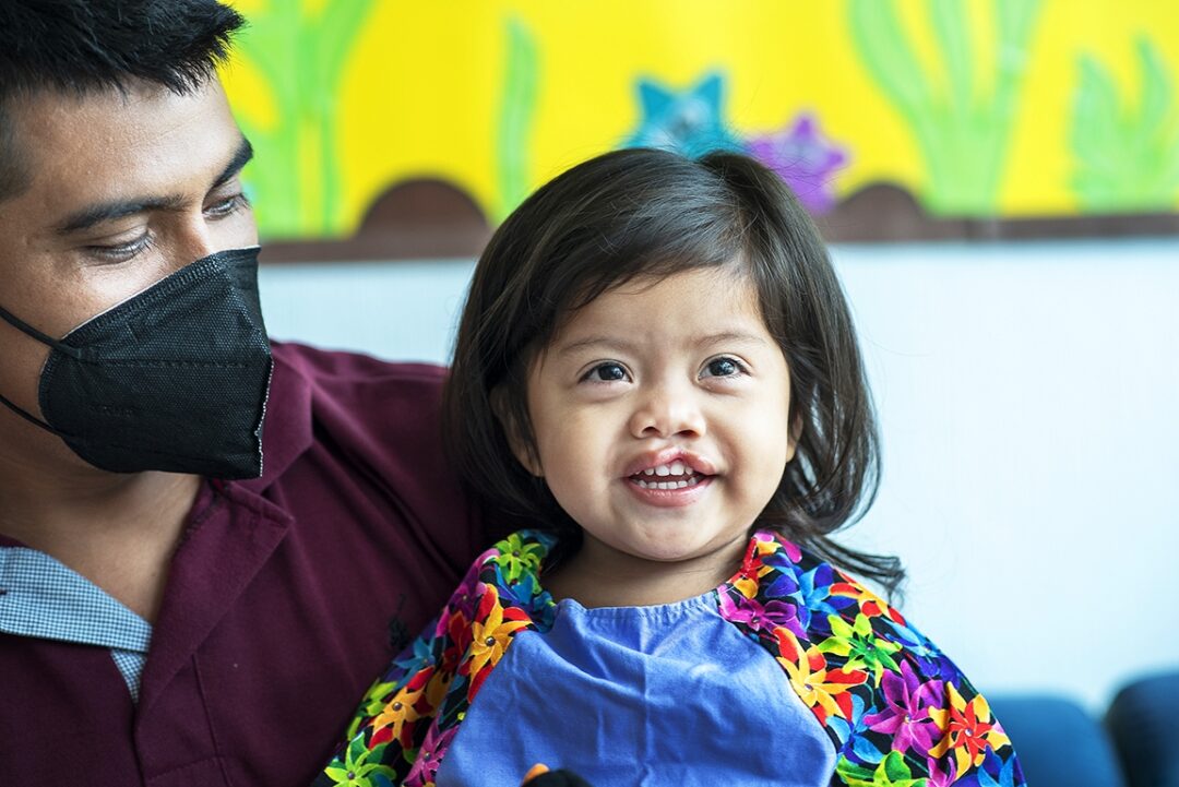 Two-year-old Lia waits with her father, Gerardo, before entering the operating room to receive her life-changing surgery during Operation Smile’s surgical programme in Guatemala City. Photo: Rohanna Mertens.