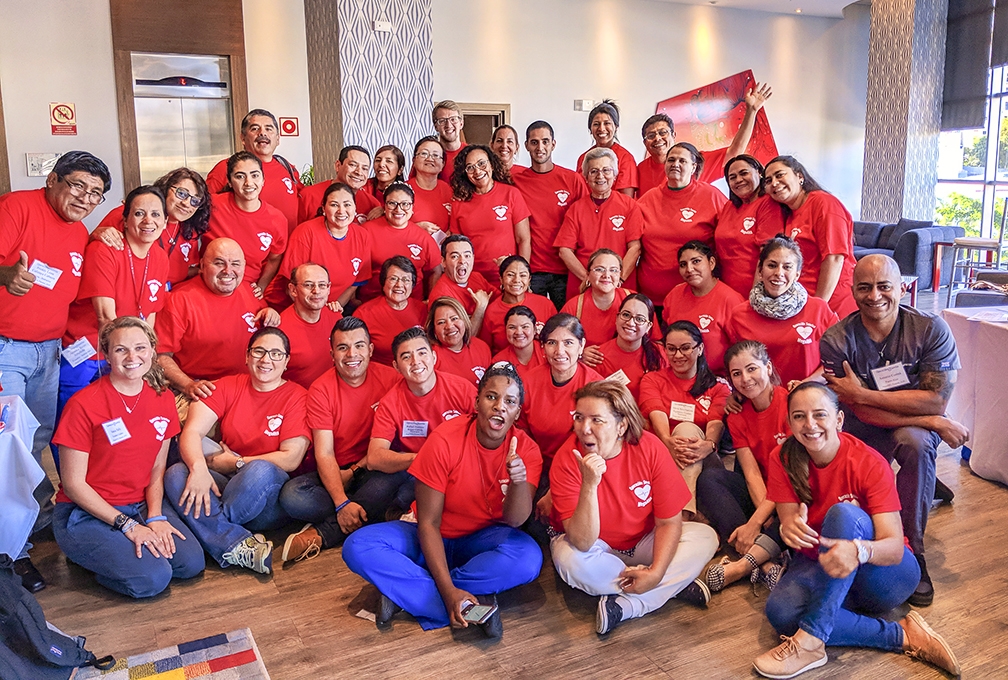 Newly-credentialed instructors, who just taught their first BLS course, pose for a photo with their trainees. This was the first course that these new instructors taught in order to receive the certification they need to teach in their own countries. Photo: Vania Tally