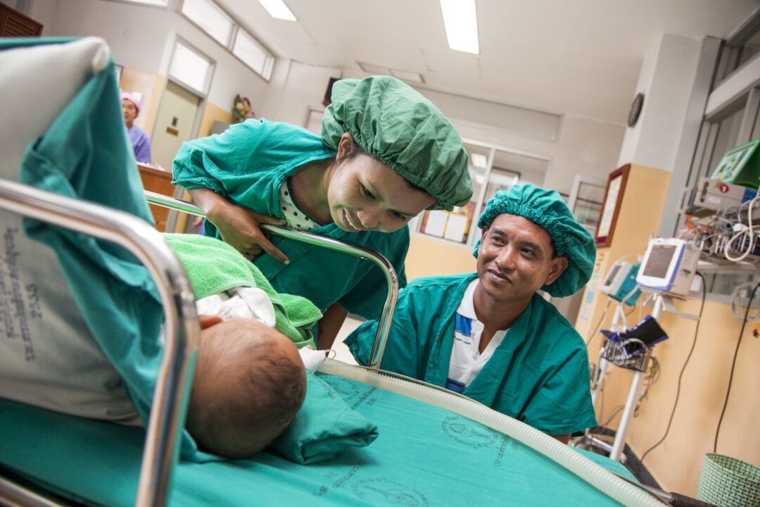 Wanna and Manus see their son Ou's smile for the first time after his cleft lip surgery. Their other twin son, Lak, also received cleft lip surgery during the same programme. Photo: Peter Stuckings.