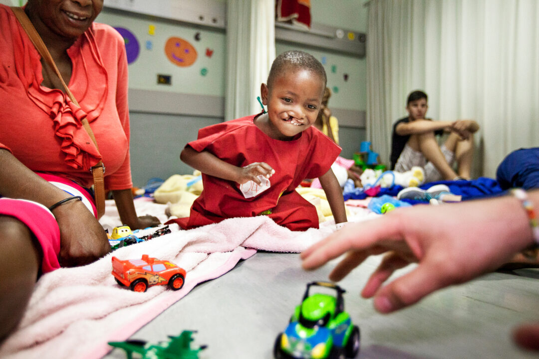 Four-year-old Keale plays with medical volunteers. Photo: Zute Lightfoot